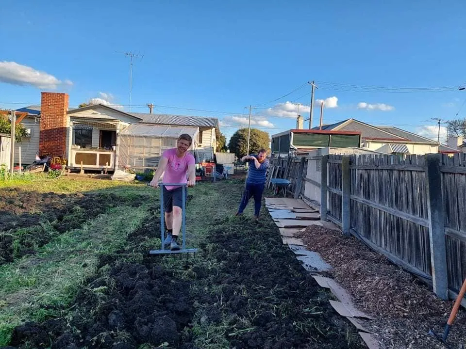 Tom and a neighbour breaking up the front lawn to make way for vegetable beds in Norlane, Geelong