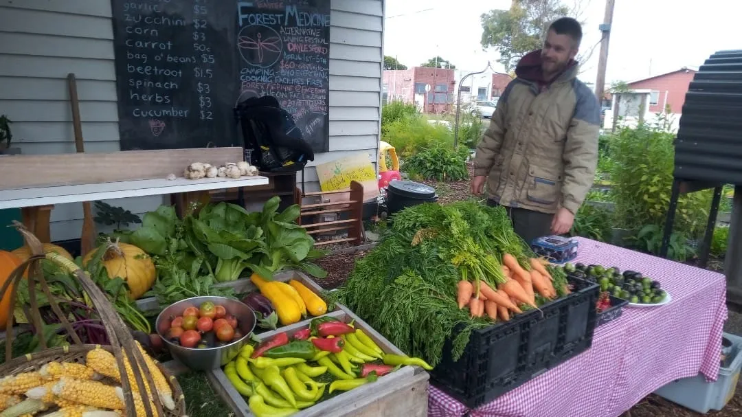 Tom at the Saturday morning market stall with seasonal produce on display