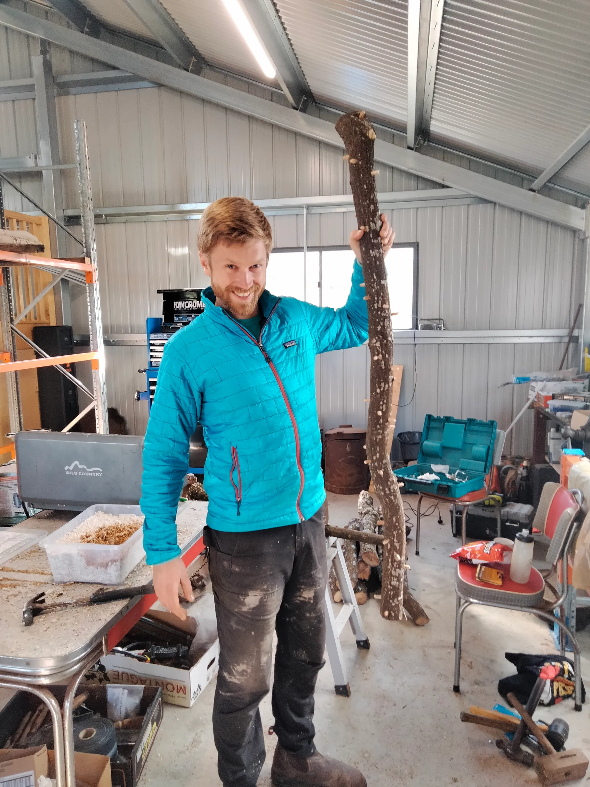 Tom in the Bellarine Fungi workshop holding an inoculated mushroom log