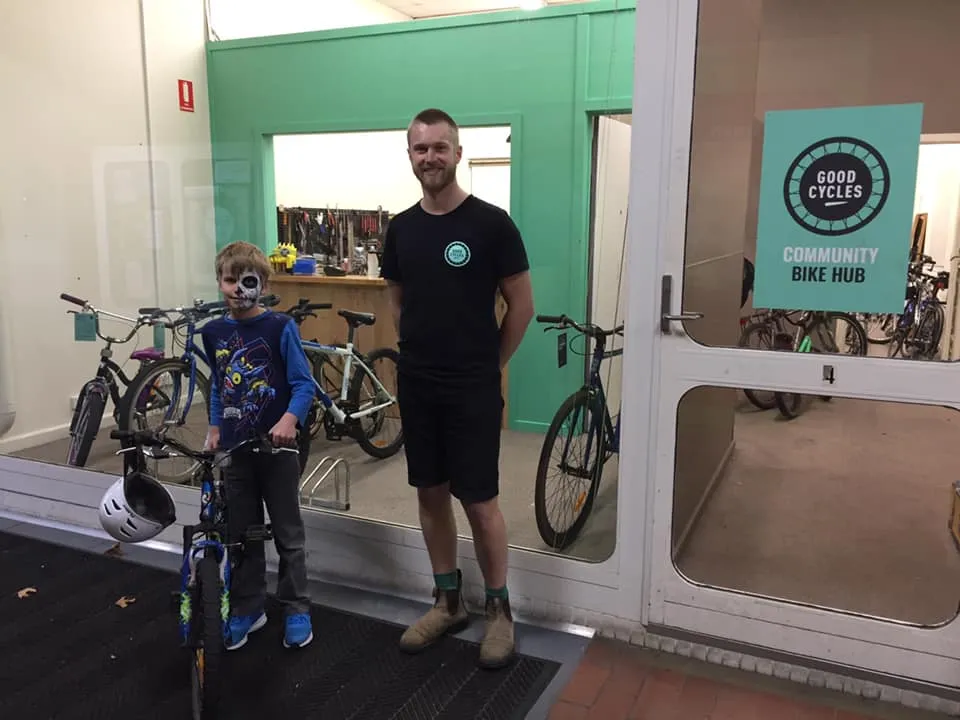 Tom Allen with a young visitor at the Good Cycles Community Bike Hub in Geelong
