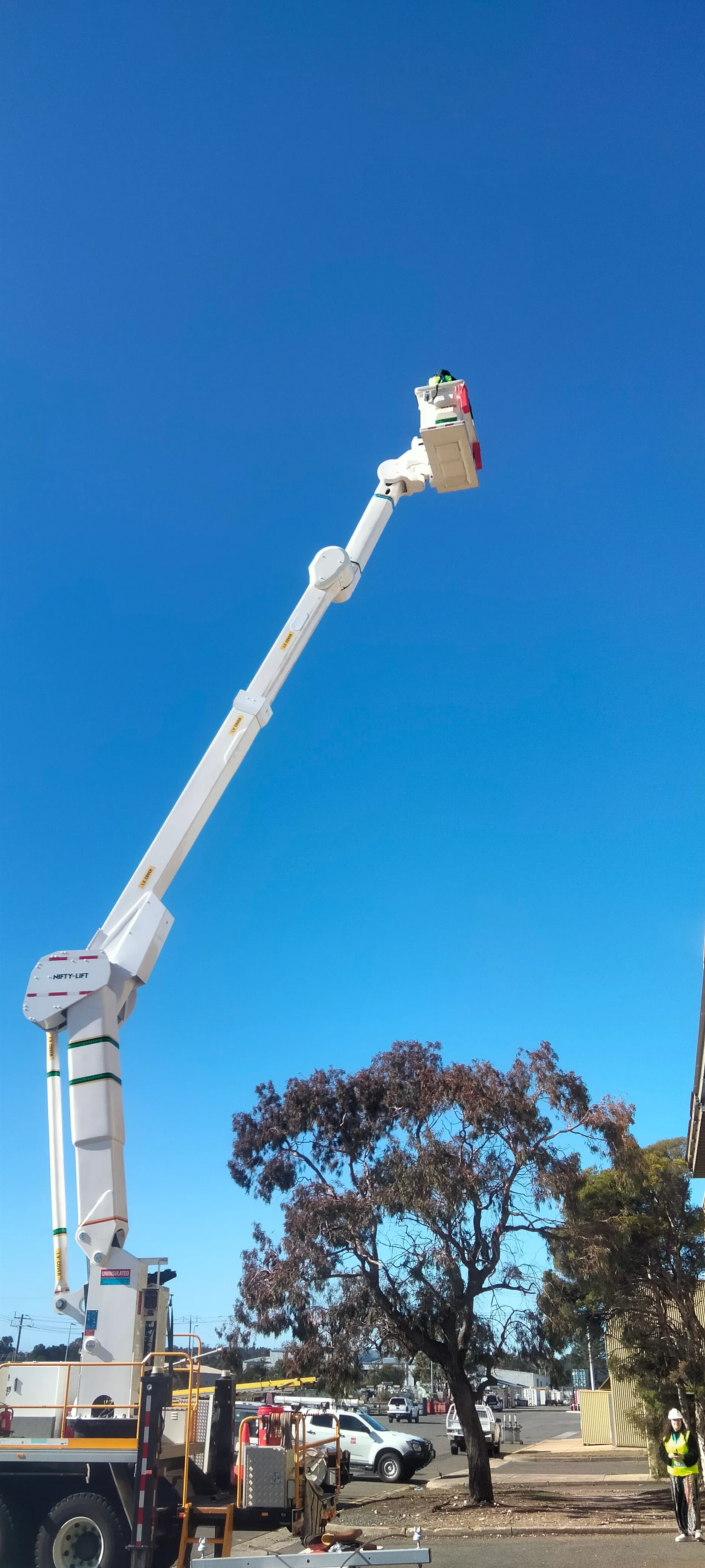 An elevated work platform against a vivid blue sky during an industry site visit